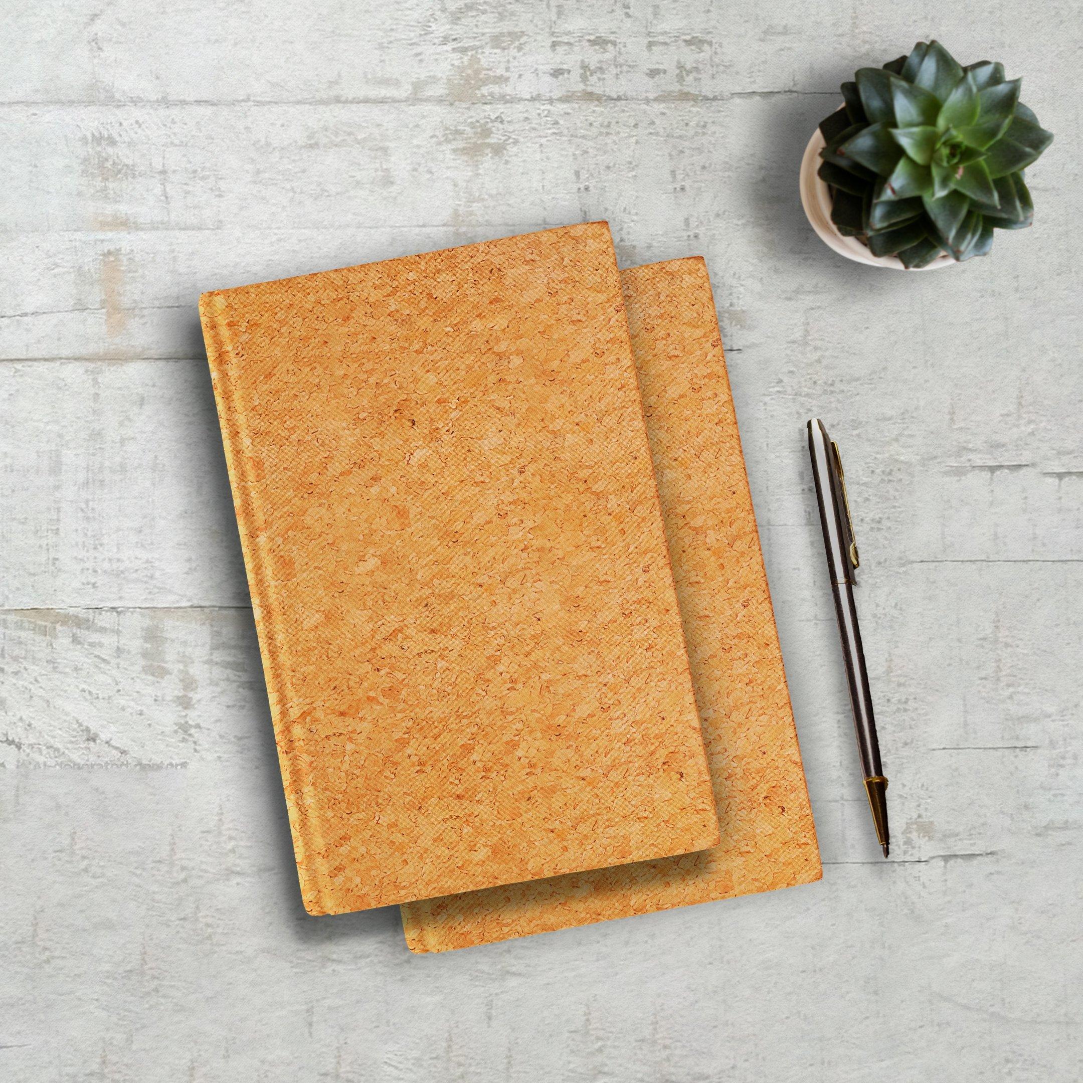Minimalist cork-covered journals with a pen and succulent